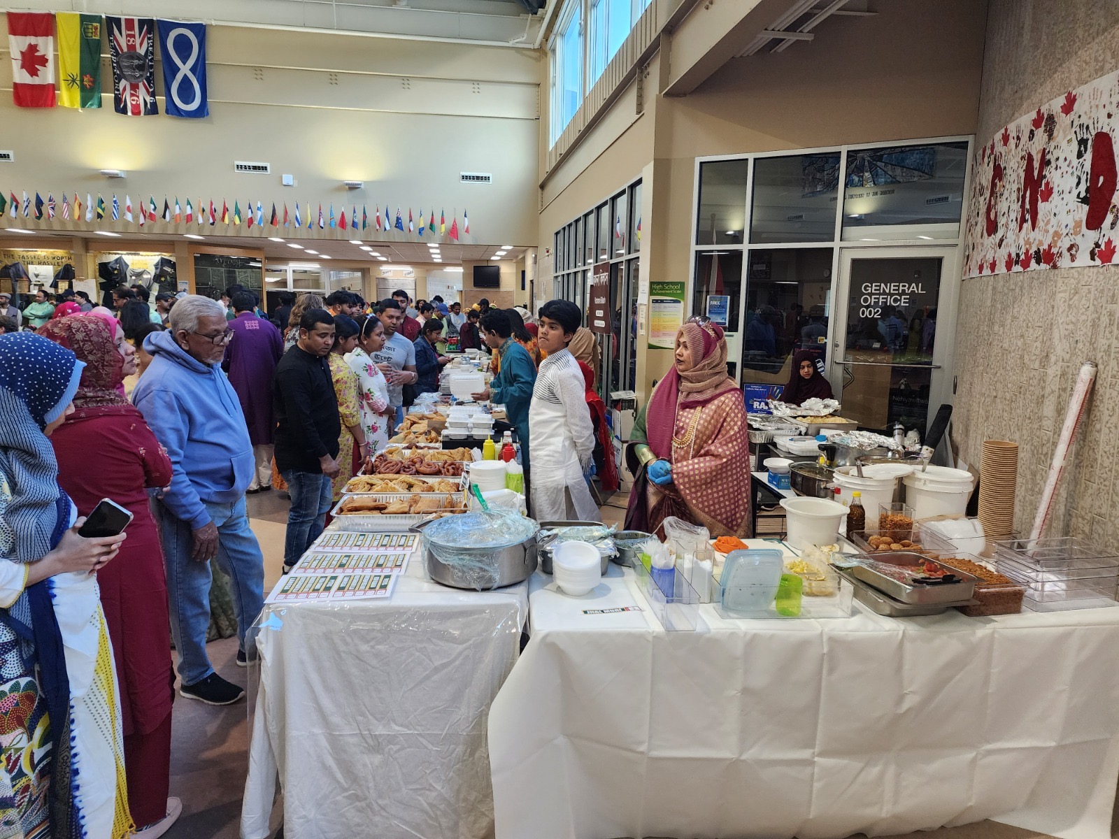 Catering table at a Saskatoon community gathering with flags overhead