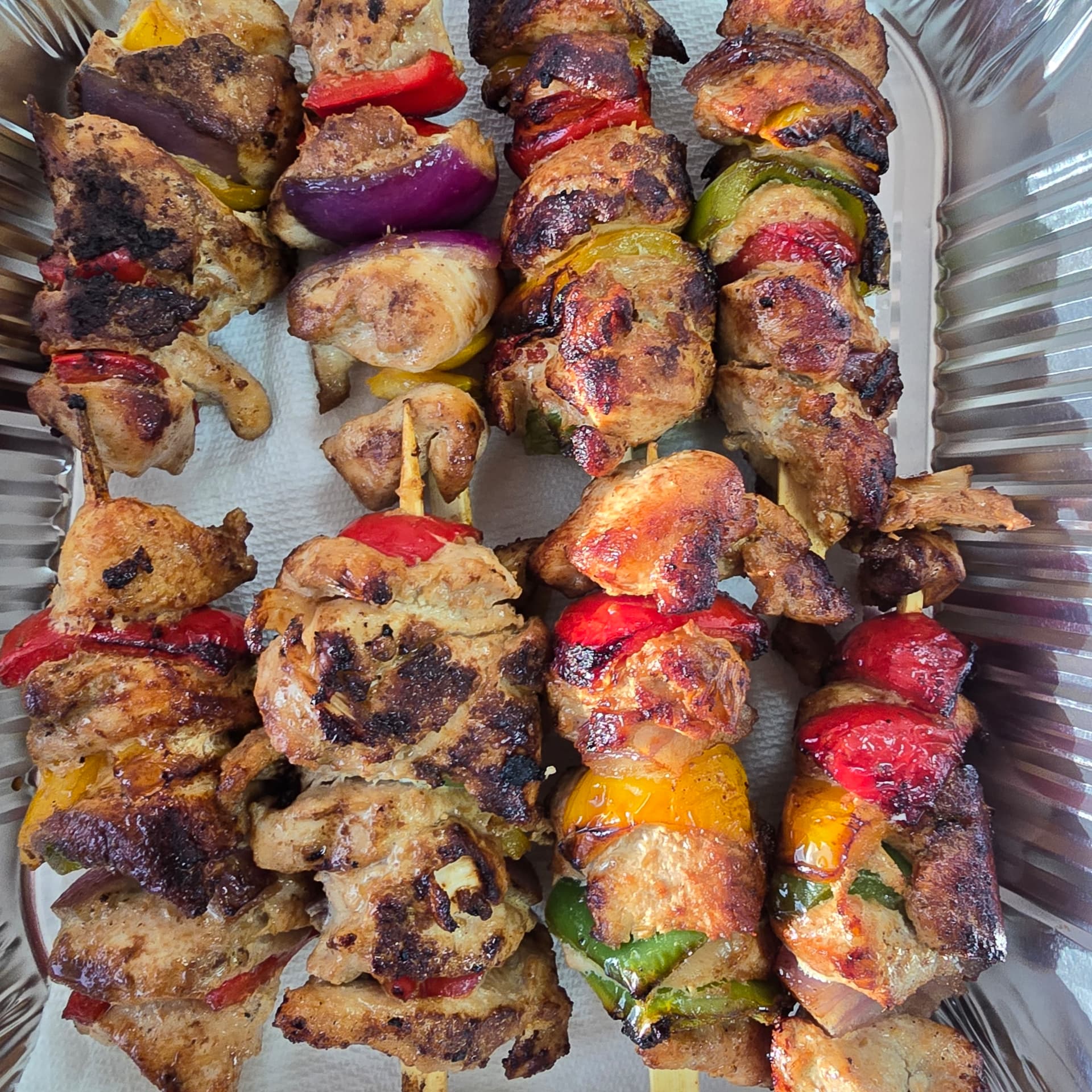 Grilled Bangladeshi chicken kabab skewers with peppers and onions