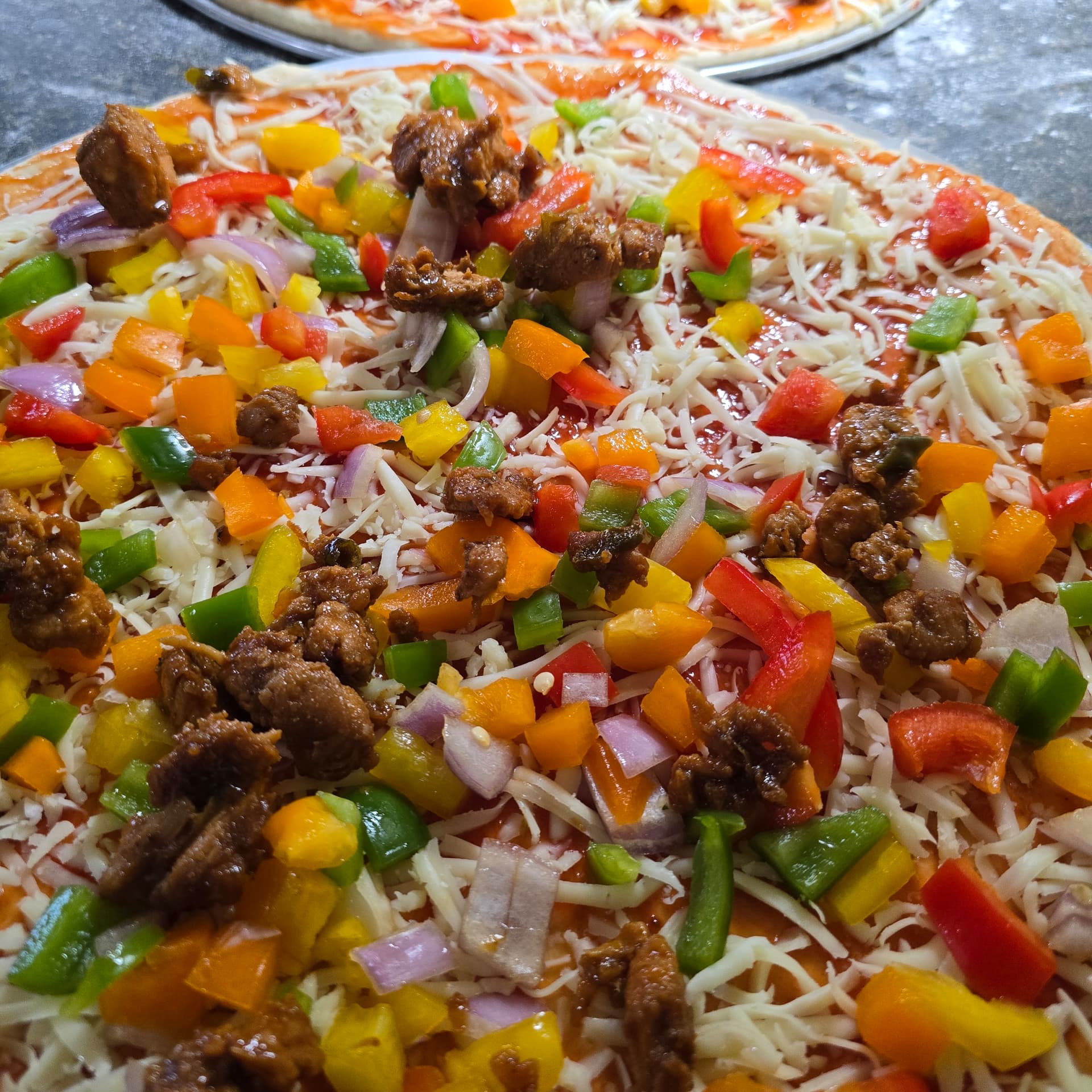 Chicken pizza fresh from the oven with melted cheese and herbs